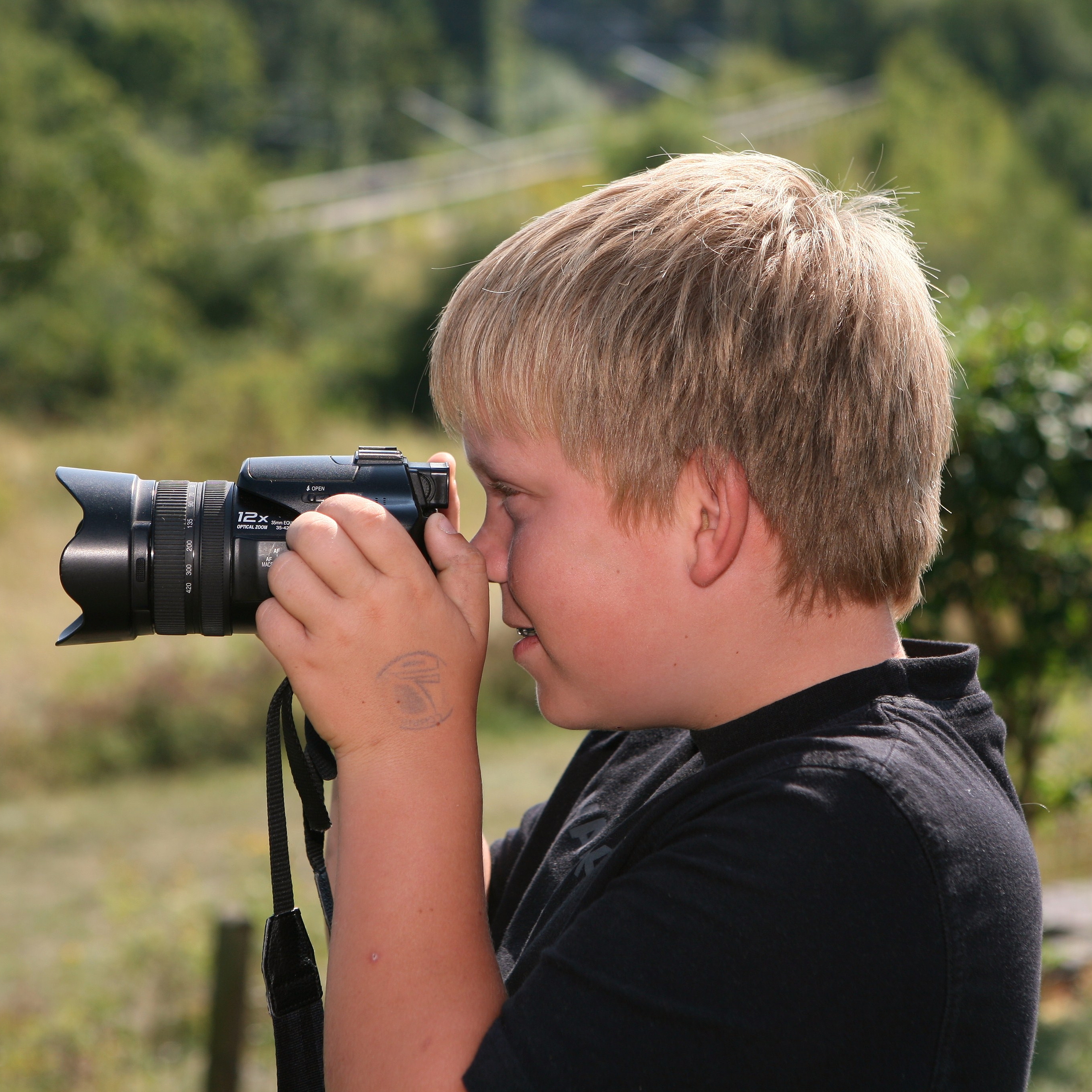 Ein Junge macht ein Foto mit einer Kamera