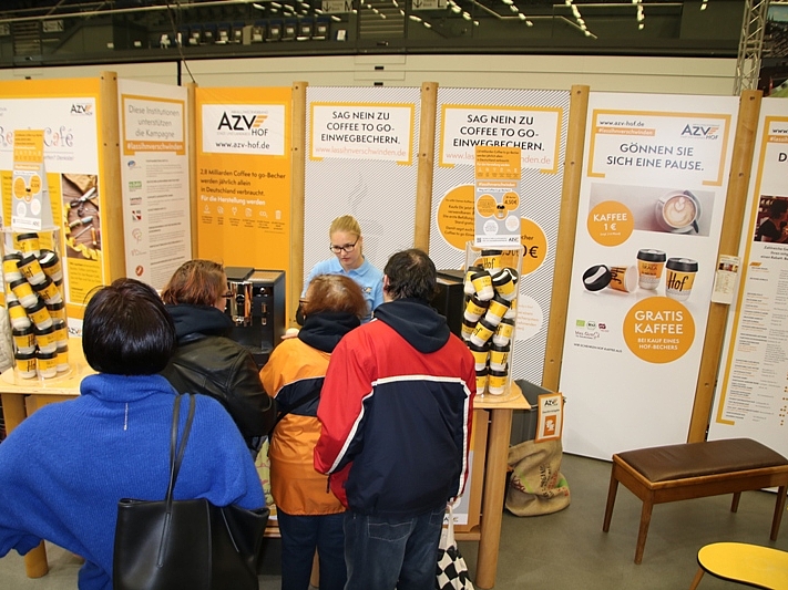 OFRA 2018: Leute stehen vor dem Kaffeeausschank. Im Hintergrund sind Rollups des AZV.